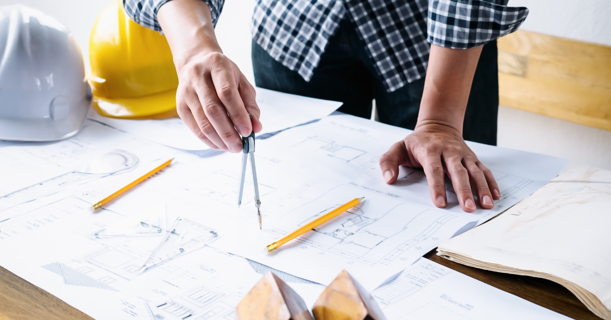 construction worker looking at commercial office construction build plans