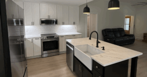 kitchen renovation with farmhouse sink installation, marble countertops, and custom cabinets