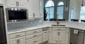 open concept kitchen with new island lighting