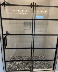 walk-in tiled shower with glass door