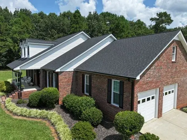 aerial view of fresh charcoal black shingles with detailed step and counter flashing